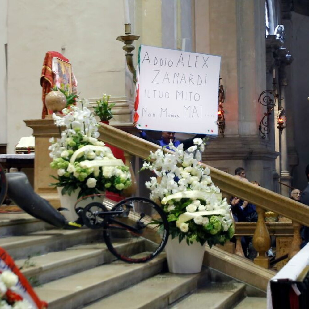 Crowd at Zanardi’s funeral in Padua. Alex’s handbike in front of the altar